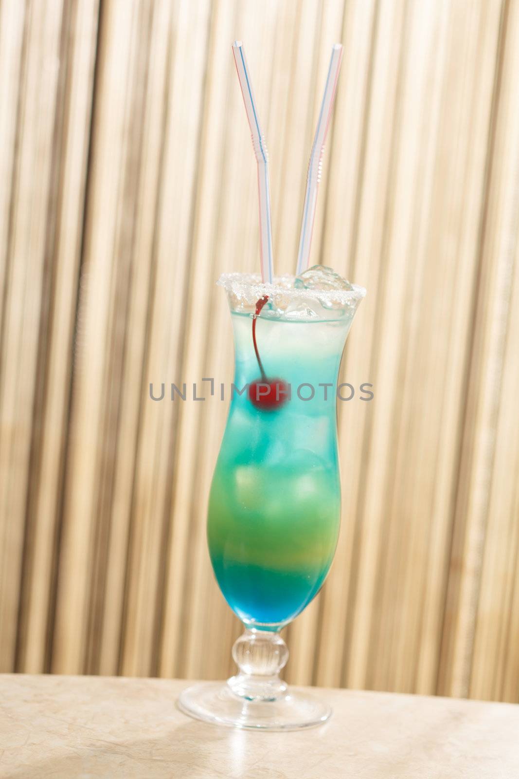 blue cocktail with cherry
