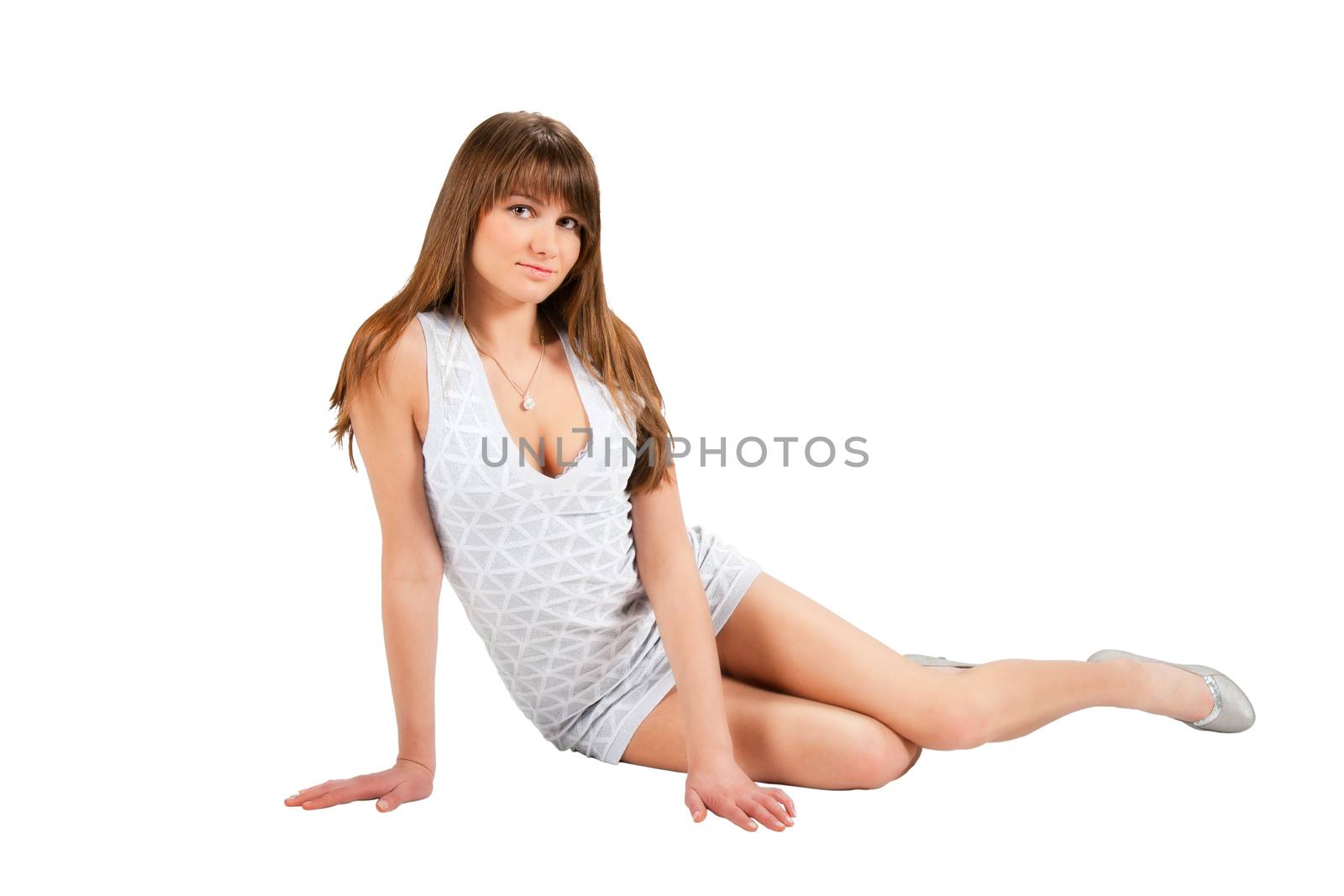 pretty woman in light dress posing sitting in studio isolated on white background