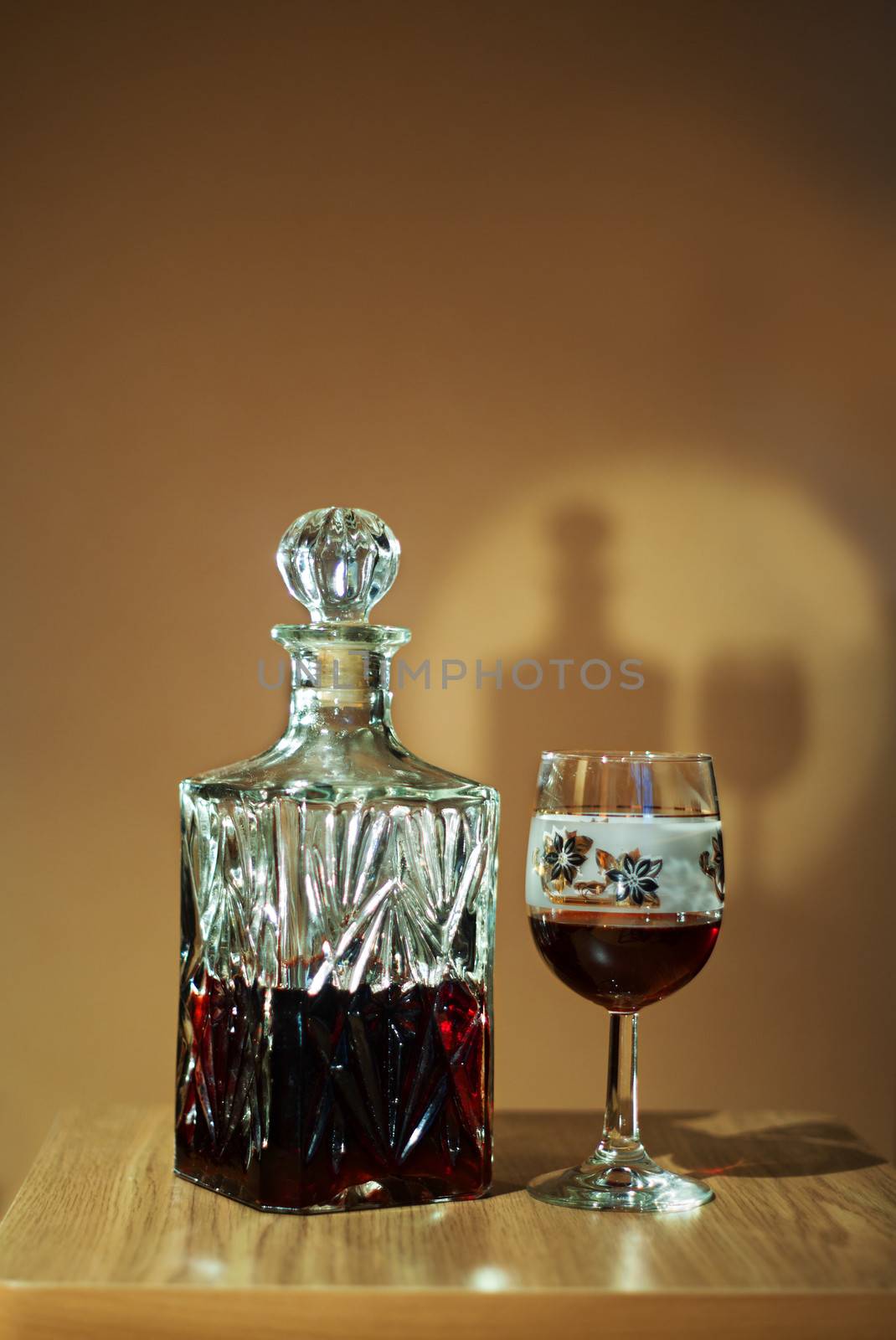crystal decanter with red wine and glass on the table