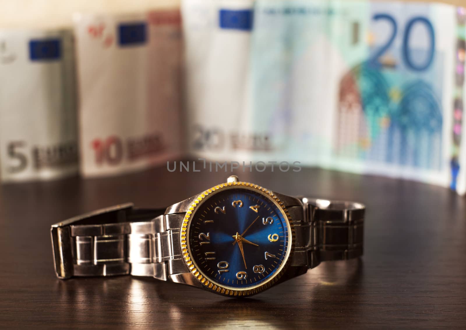 watch against the background of different banknotes