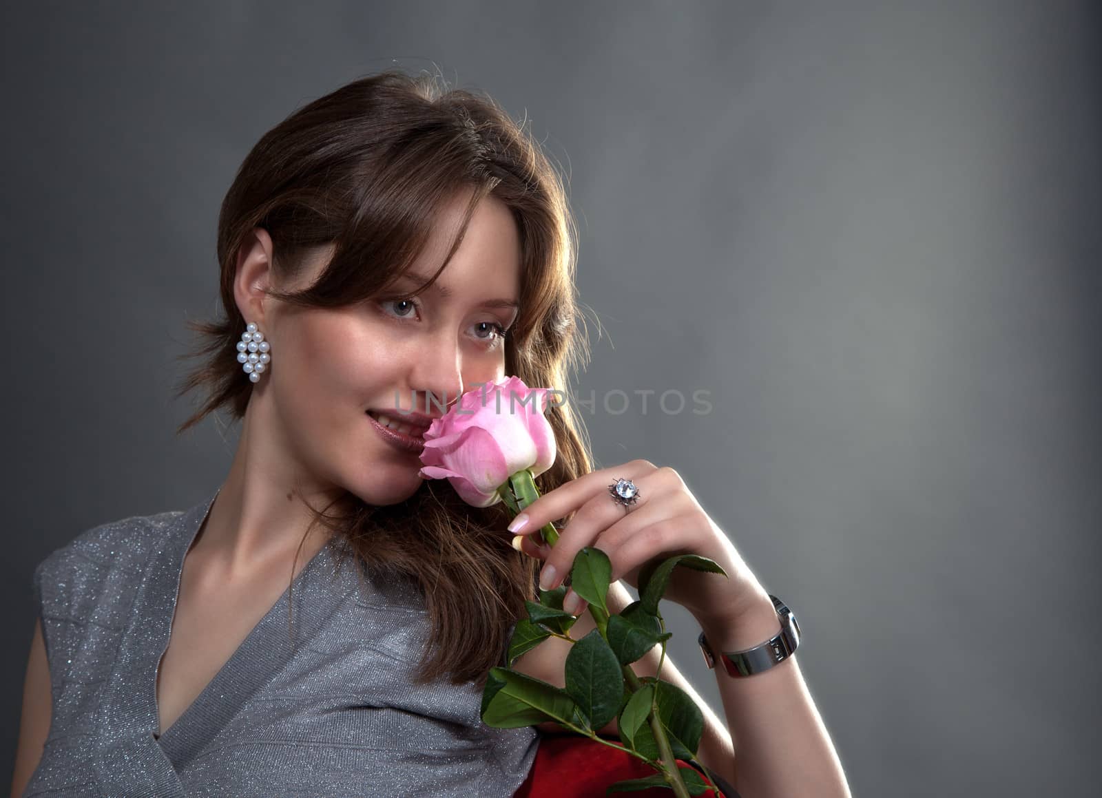 portrait of lovely girl with pink rose in studio