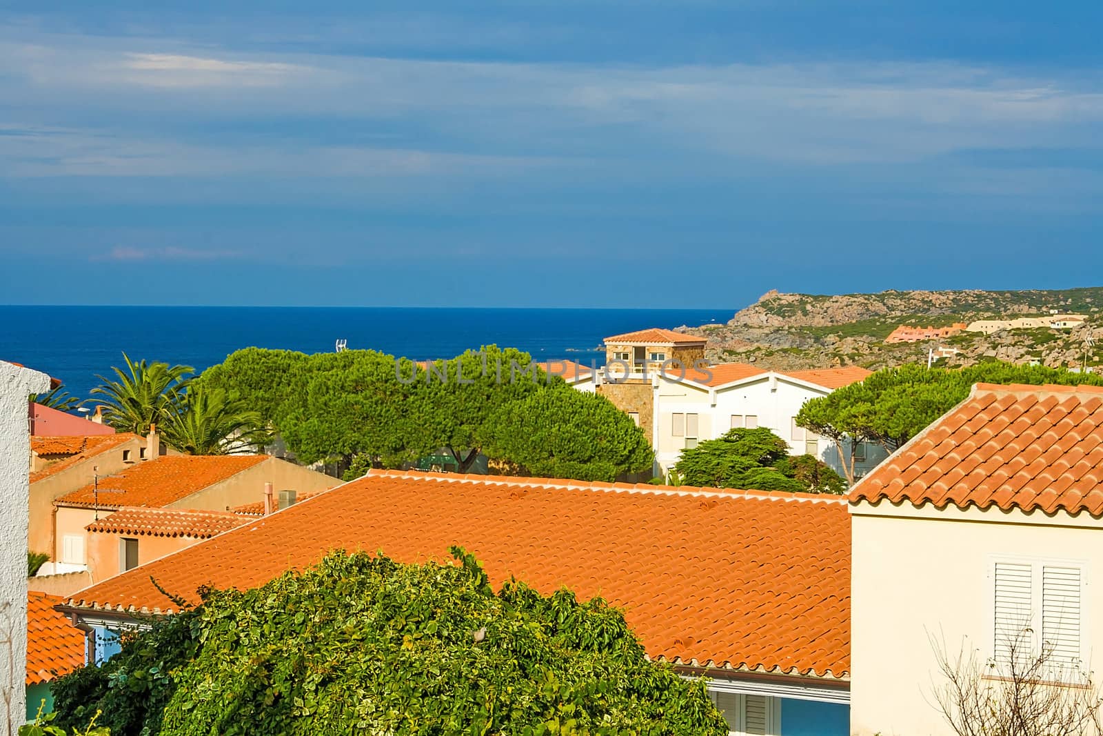 view over houses to the coast of sardinia
