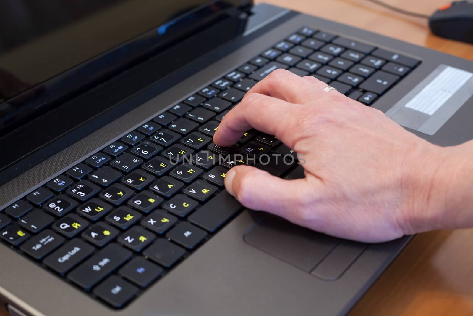 man's hand on a black computer keyboard