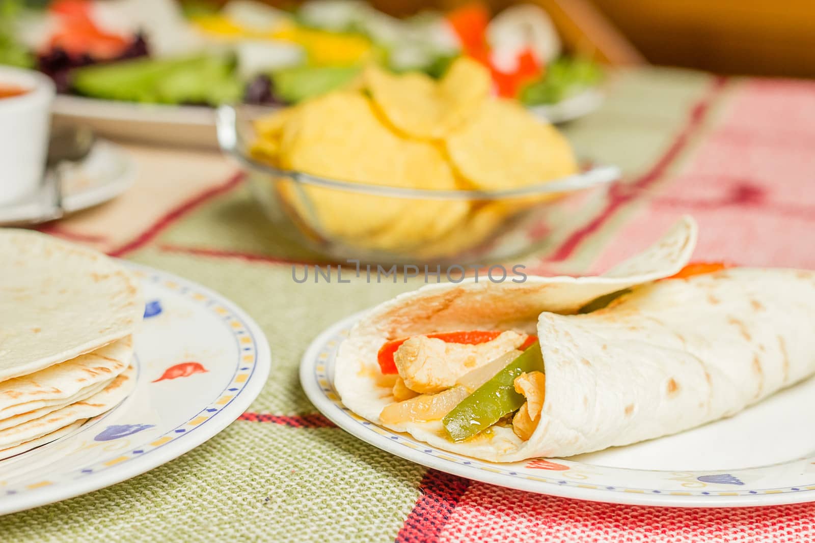Traditional mexican food with a plate of chicken fajita, tortill by doble.d