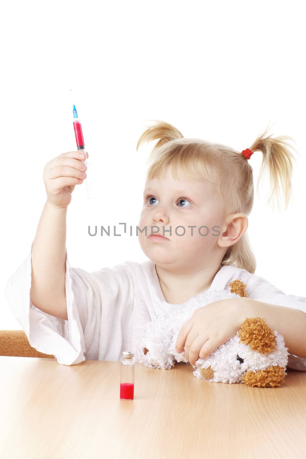 child playing as a doctor with syringe