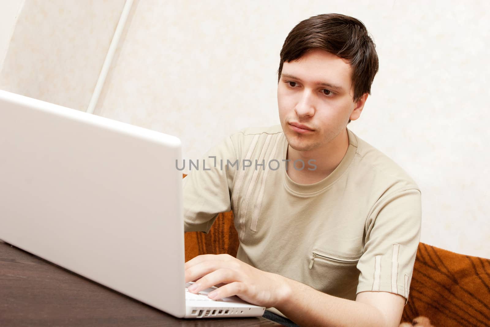 young man with notebook indoors