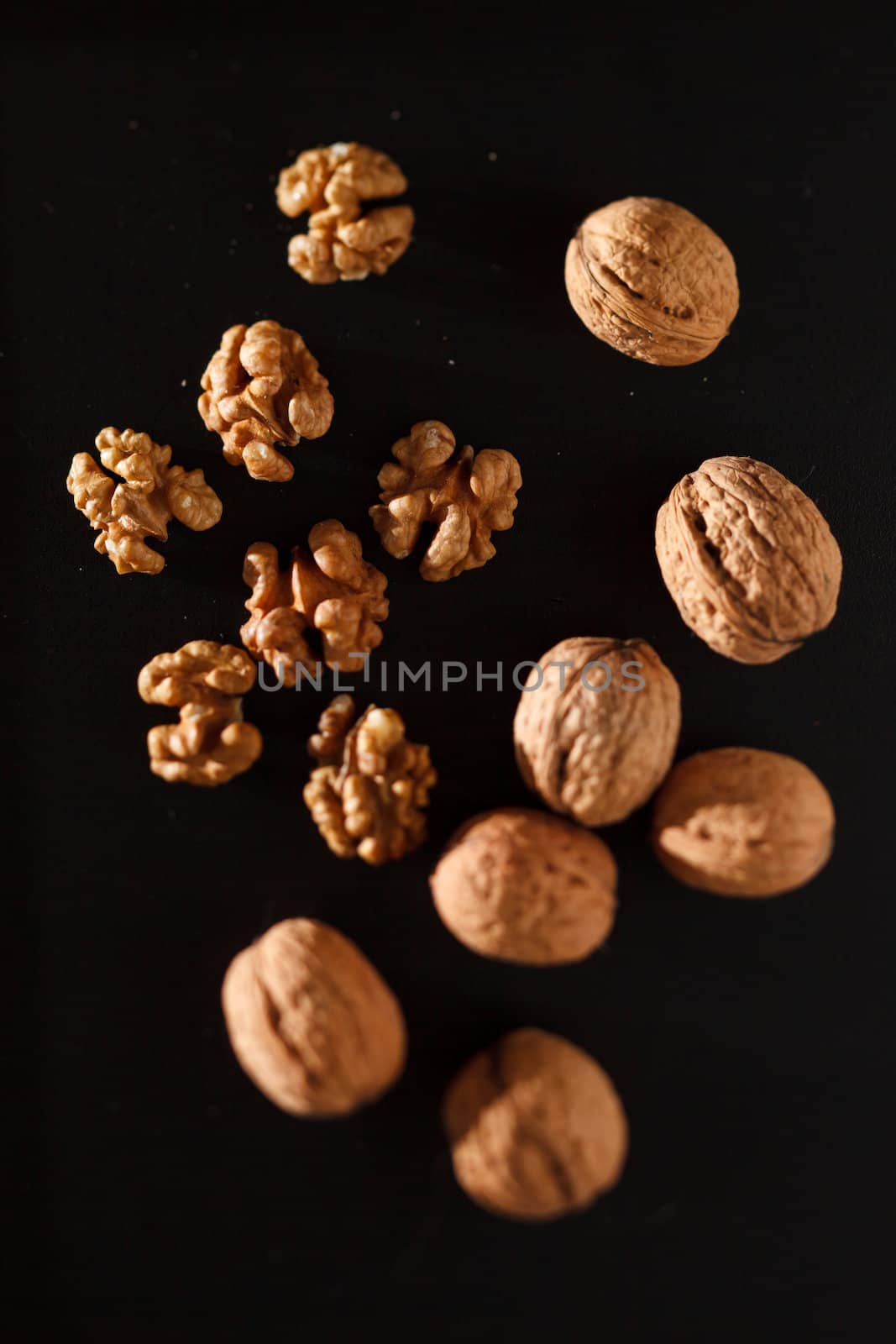 walnuts on black background by shebeko