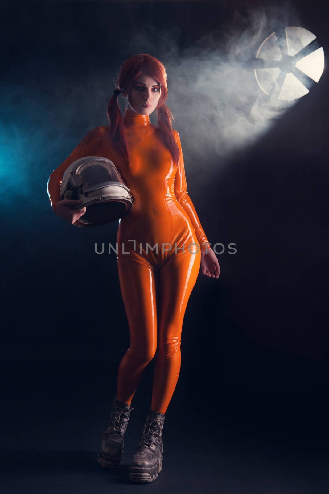 Sexy girl in latex catsuit holding helmet, sci-fi setting 