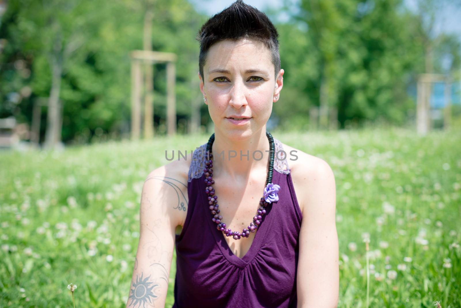 beautiful hipster short hair woman in the park in the city