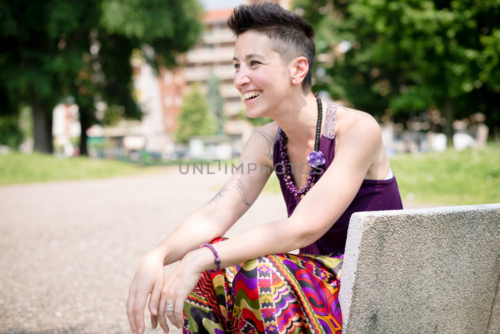 beautiful hipster short hair woman in the park in the city