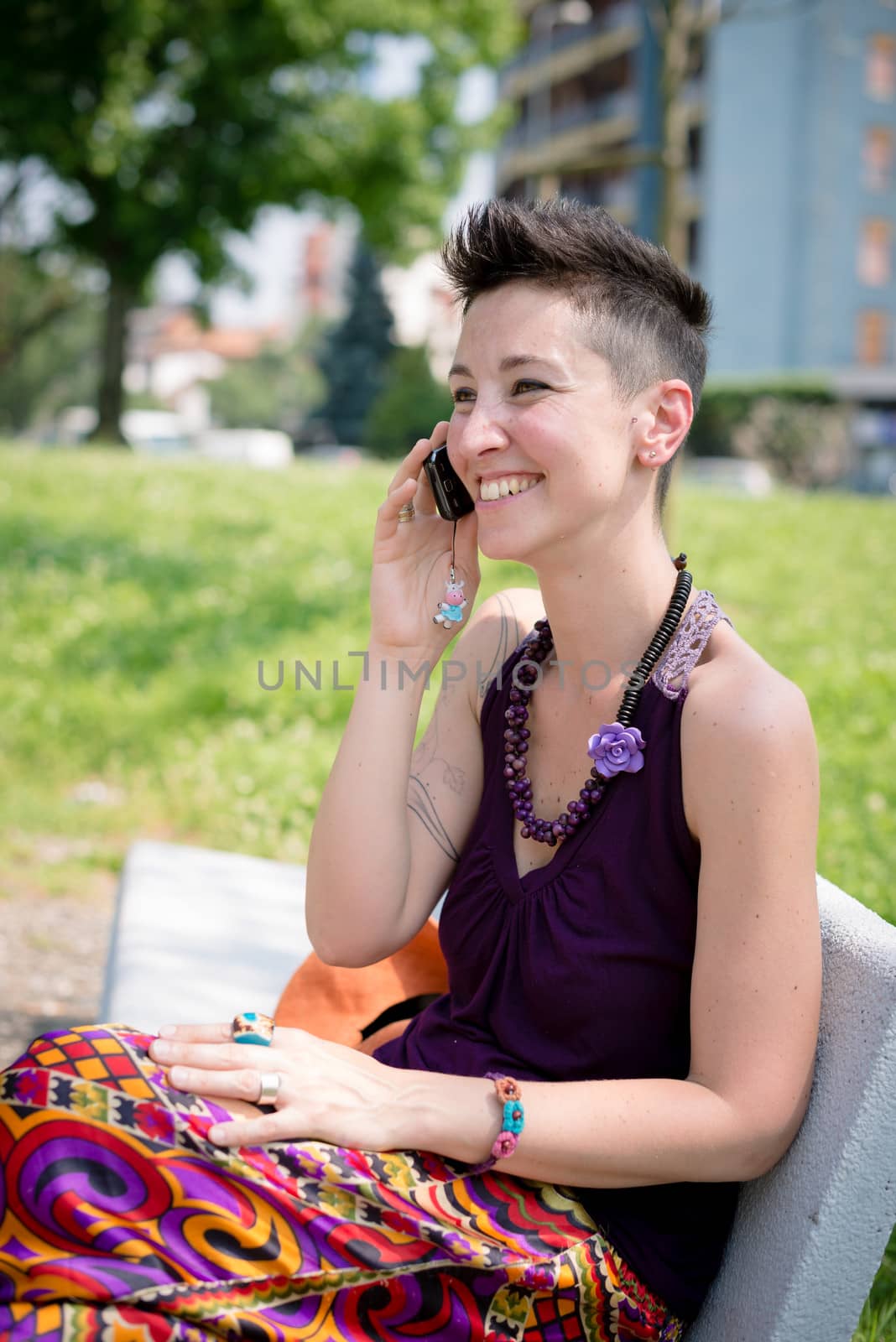 beautiful hipster short hair woman in the park in the city