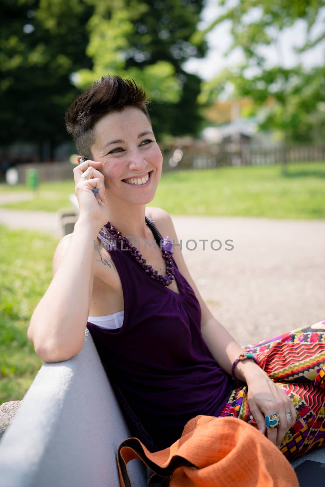 beautiful hipster short hair woman in the park in the city