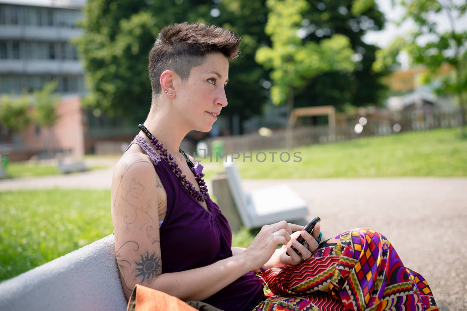 beautiful hipster short hair woman in the park in the city