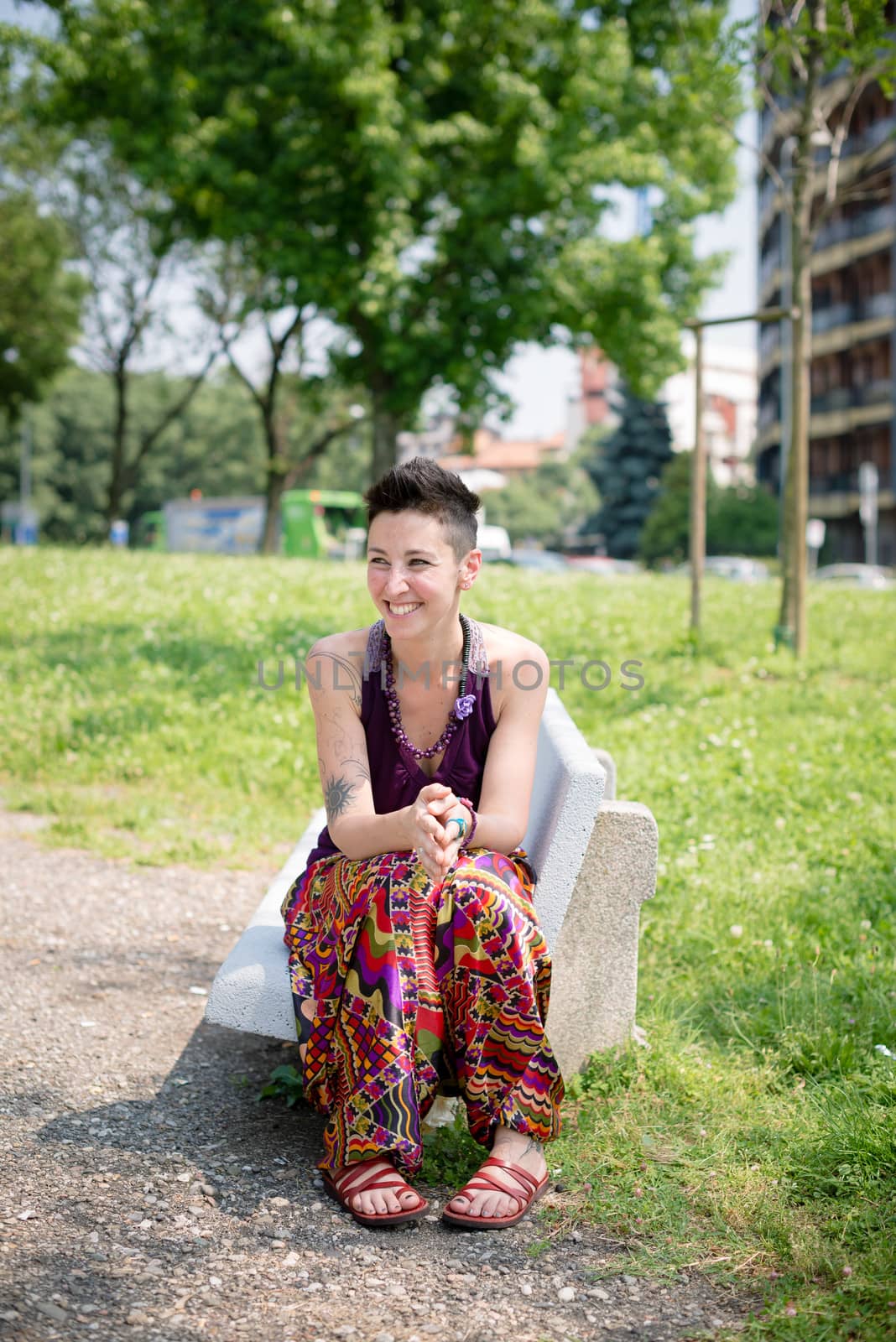 beautiful hipster short hair woman in the park in the city