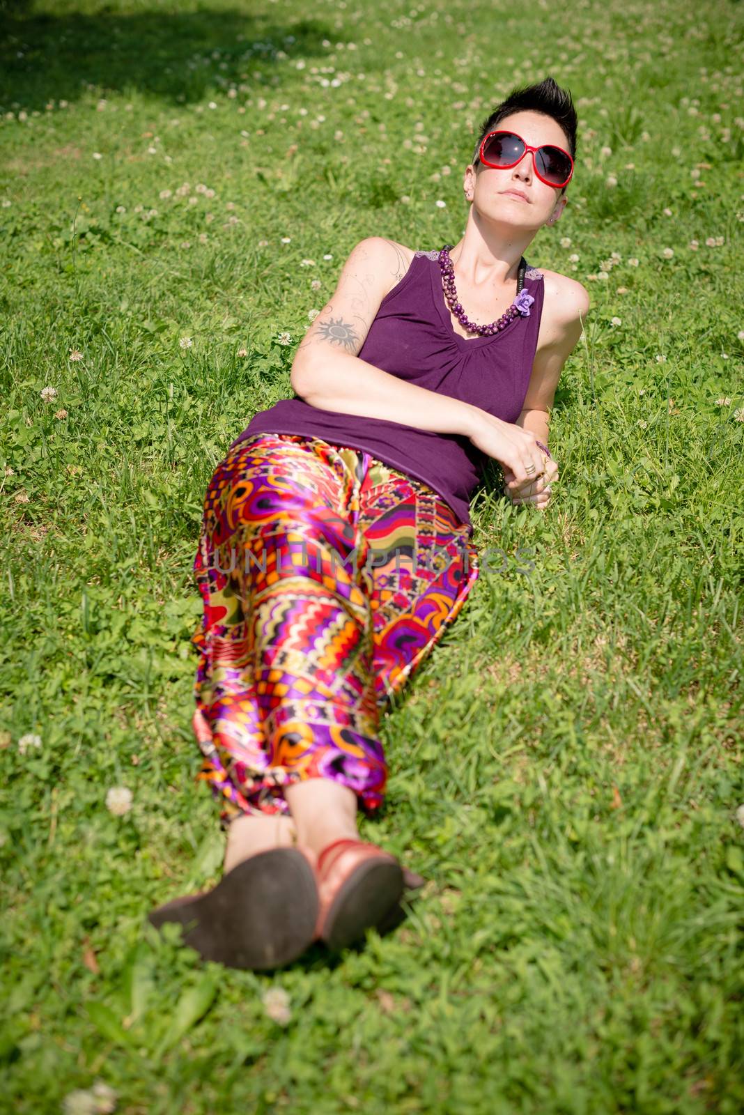 beautiful hipster short hair woman in the park in the city