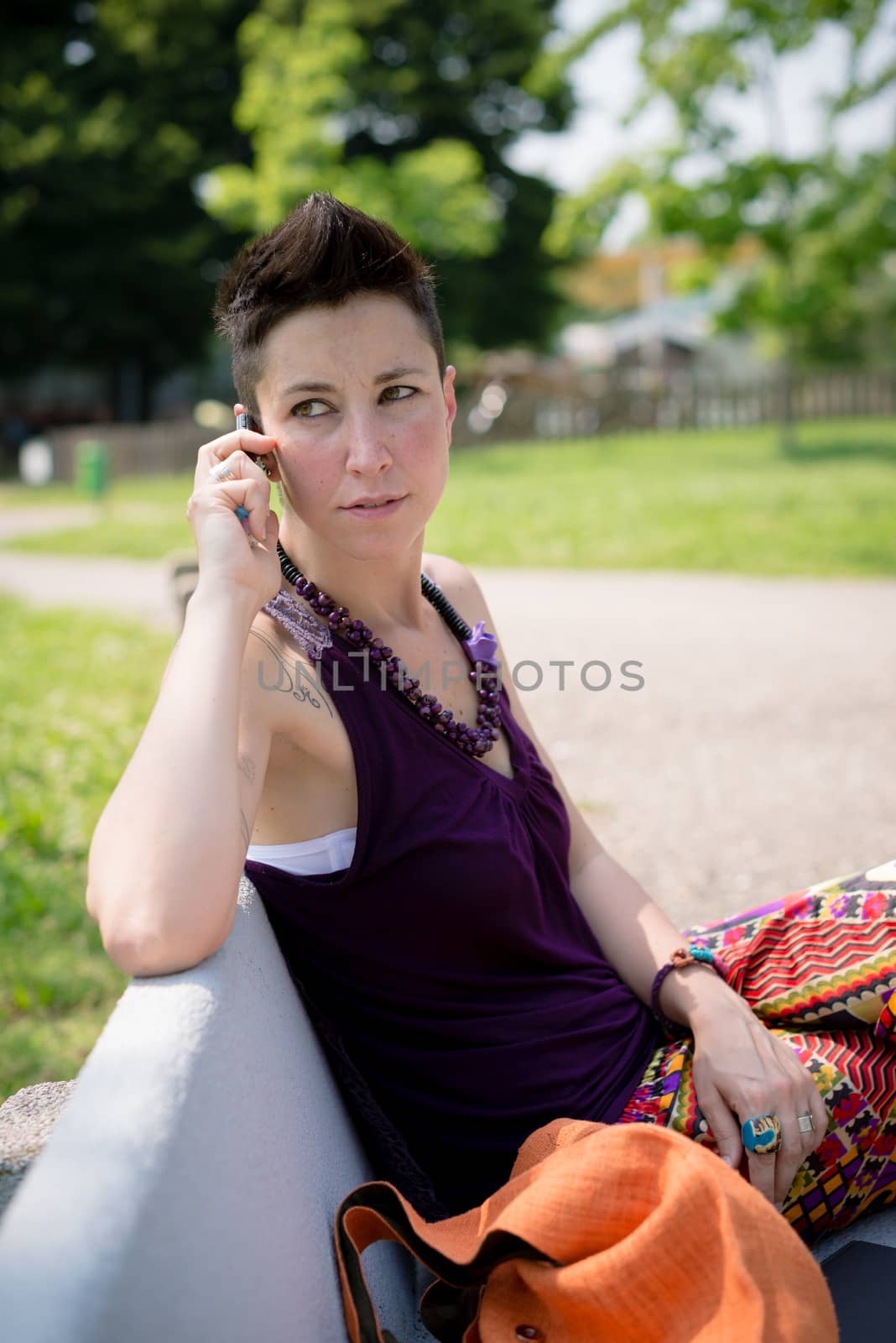 beautiful hipster short hair woman in the park in the city