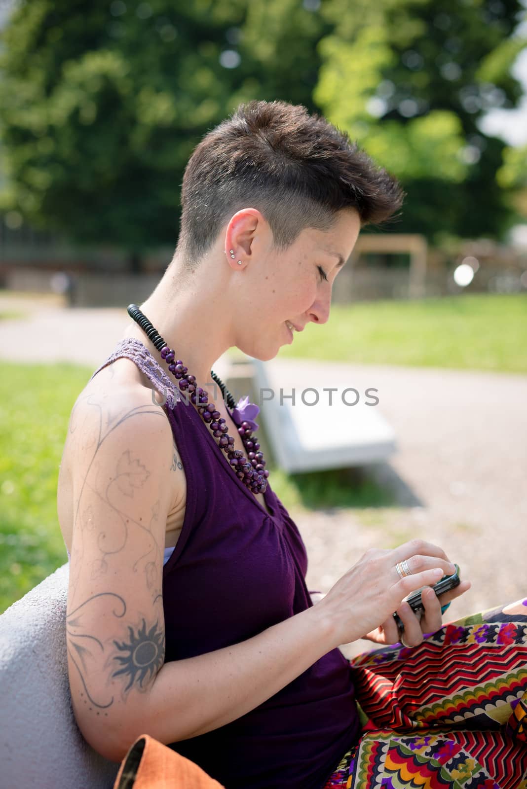 beautiful hipster short hair woman in the park in the city