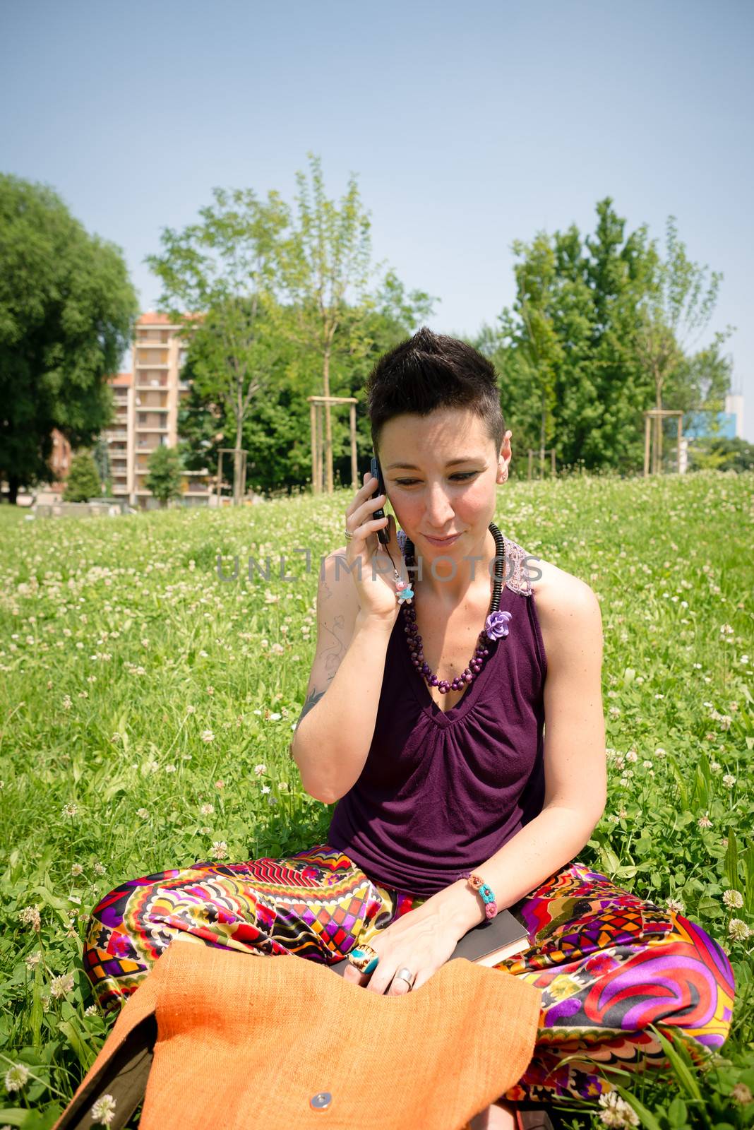 beautiful hipster short hair woman in the park in the city