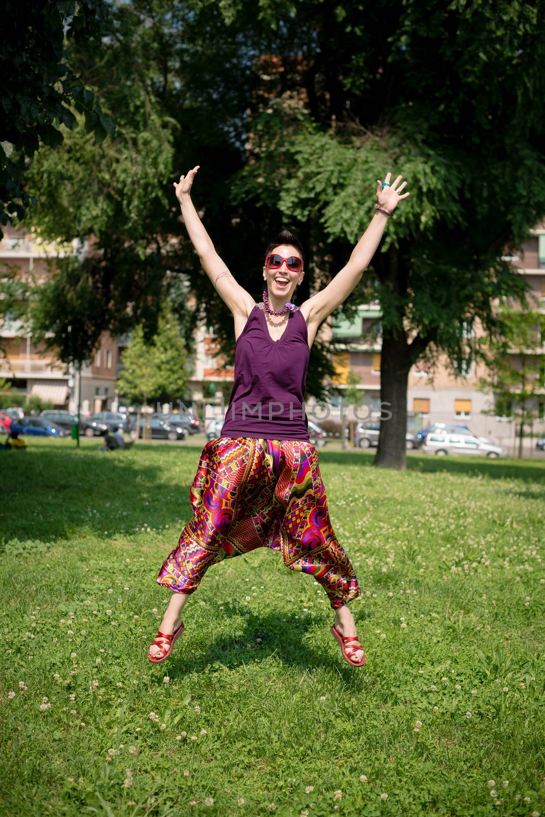 beautiful hipster short hair woman in the park in the city