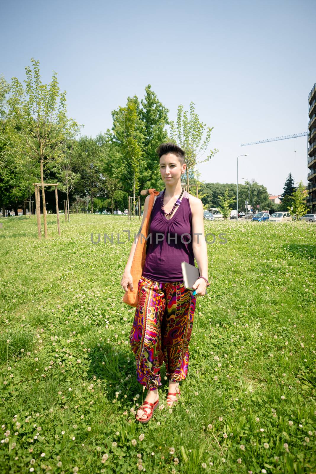 beautiful hipster short hair woman in the park in the city