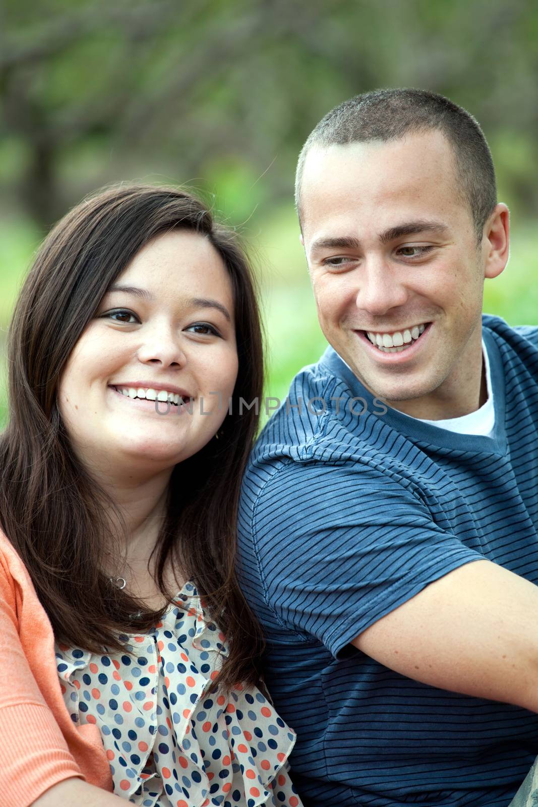 Young happy couple enjoying each others company outdoors.