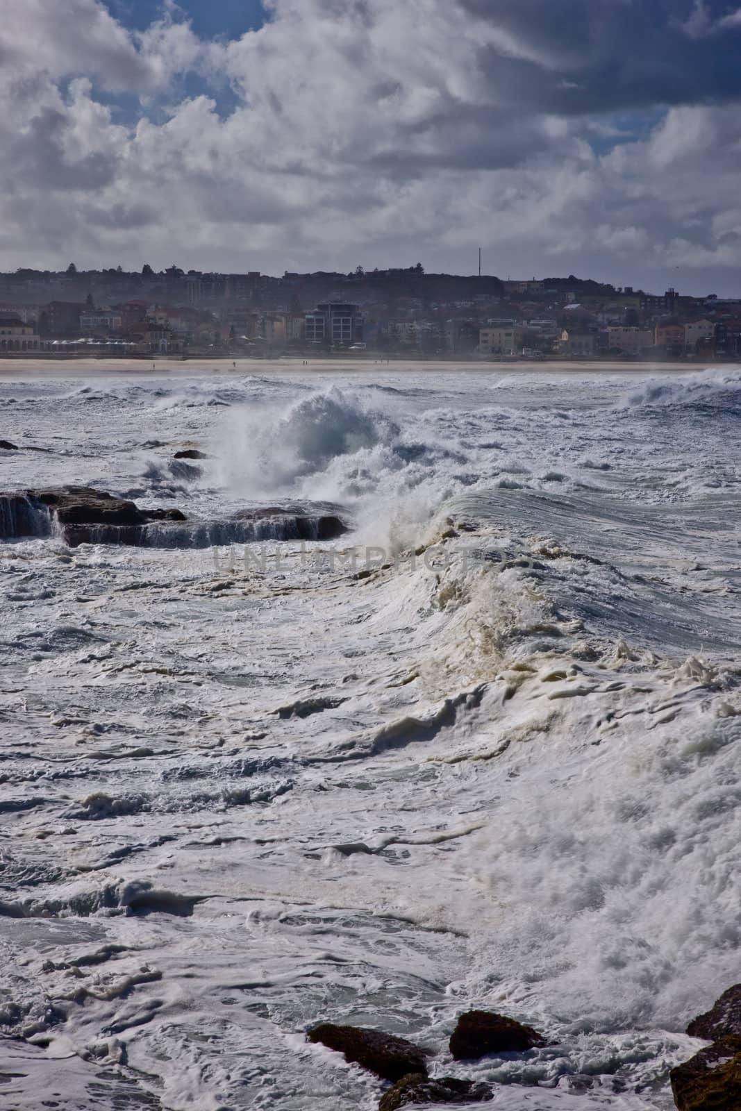 Big wave with sea foam over the stormy sky