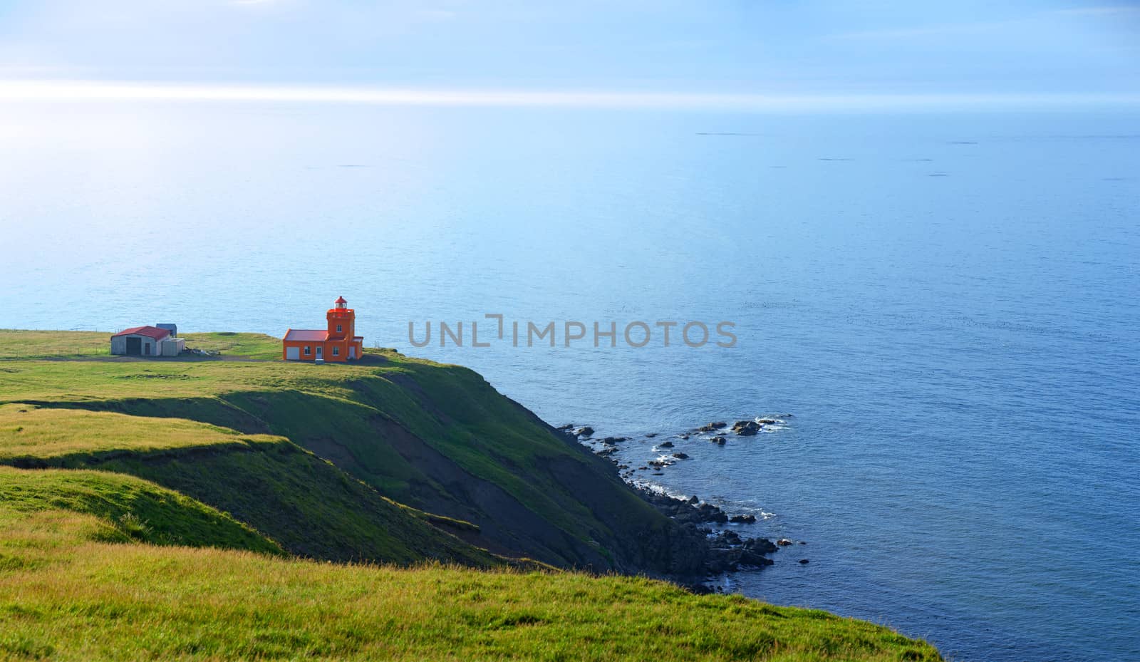 North Iceland Sea Landscape with Orange Lighthouse and Blue Sky. Panorama