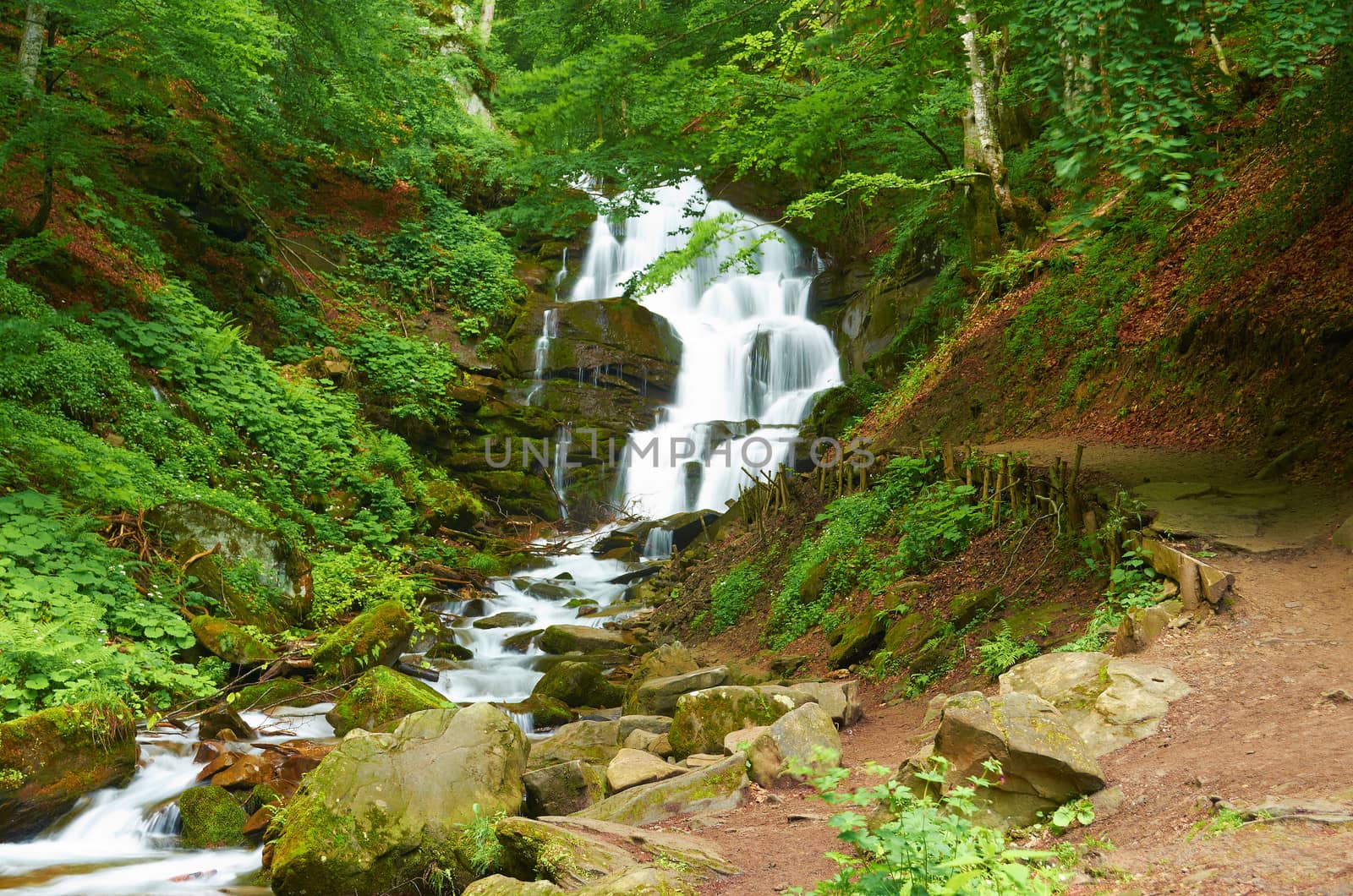 Mountain waterfall in the European mountains in summer