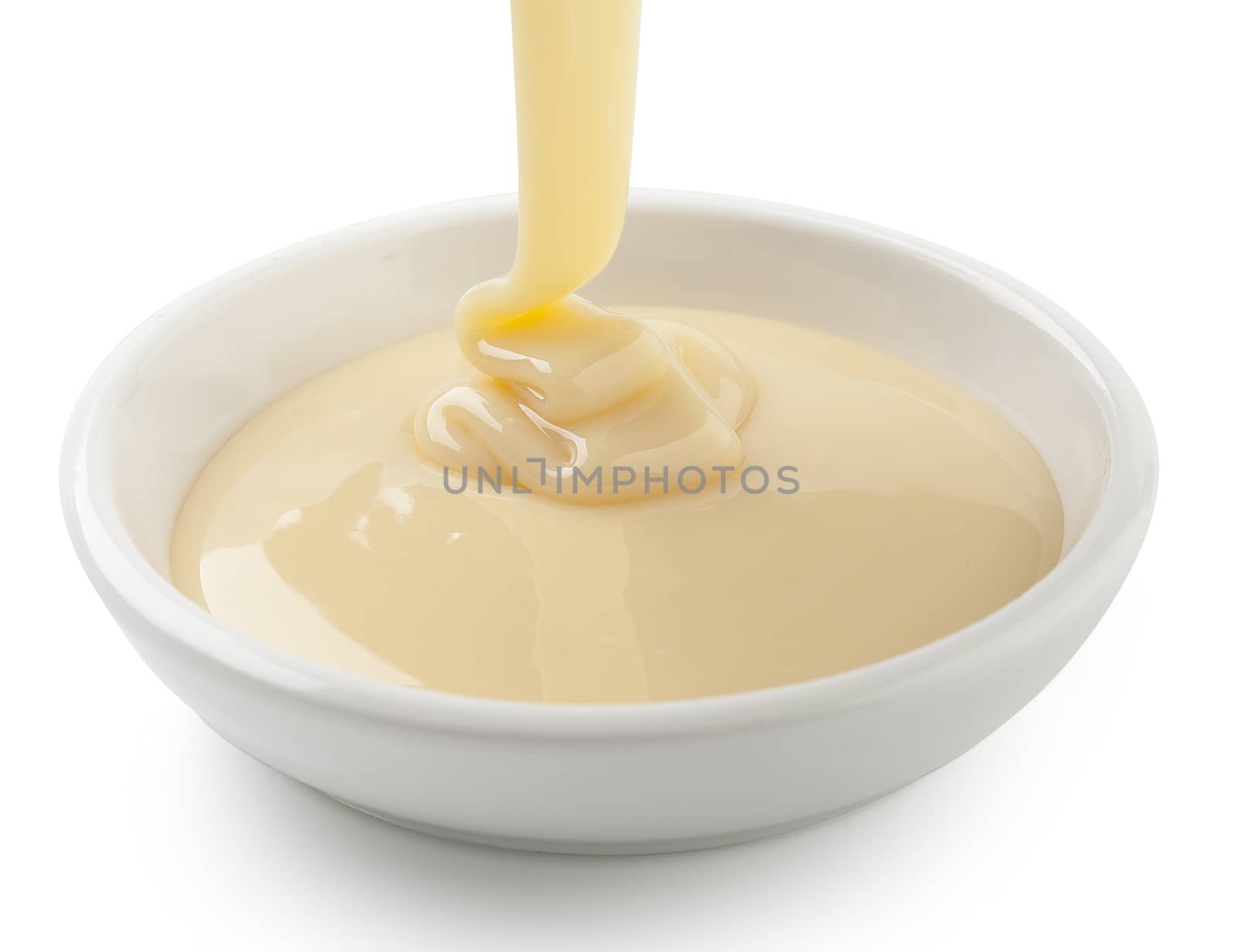 Condensed milk flowing in white plate