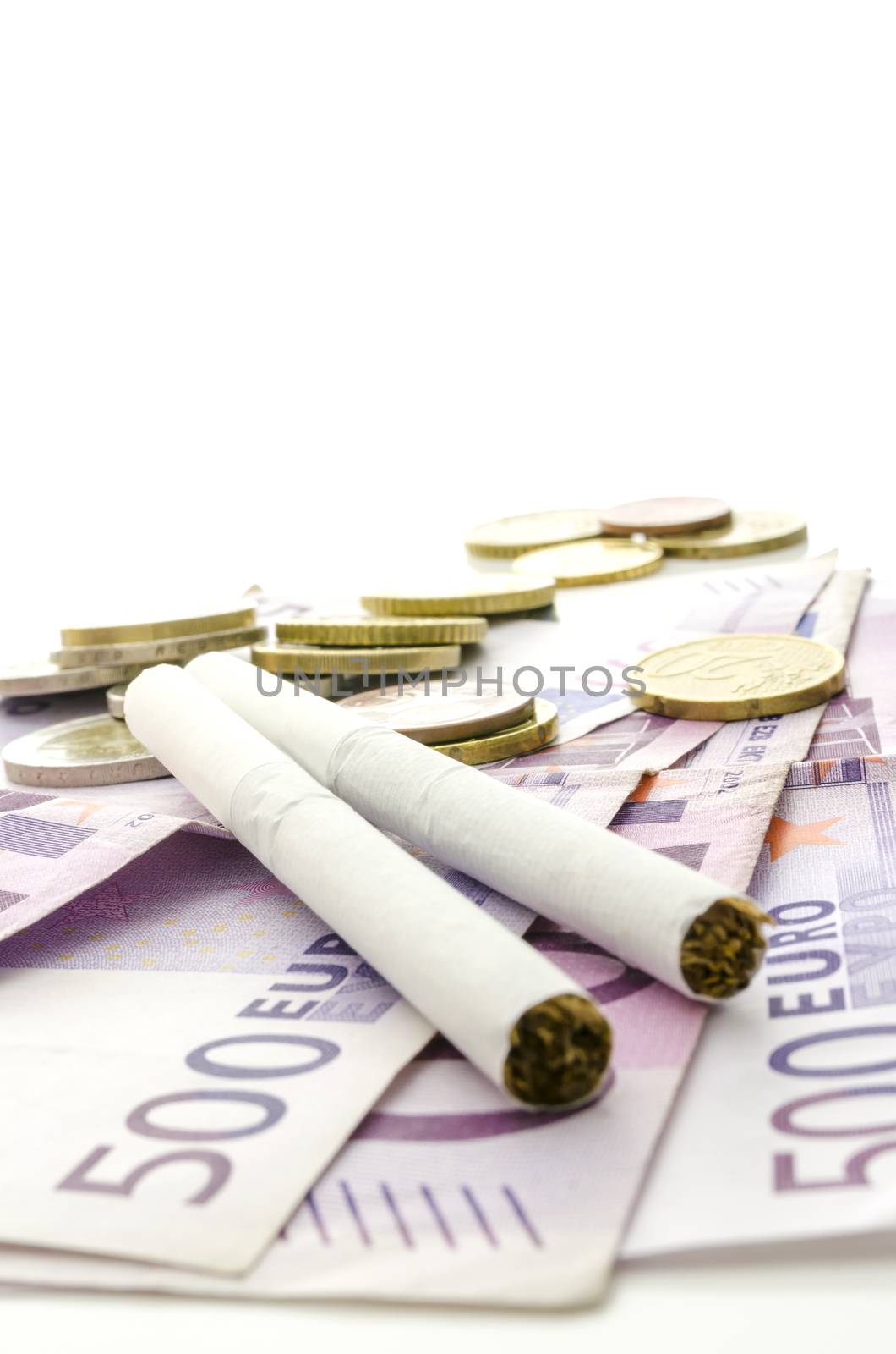 Cigarettes on Euro banknotes representing how expensive smoking habit is.