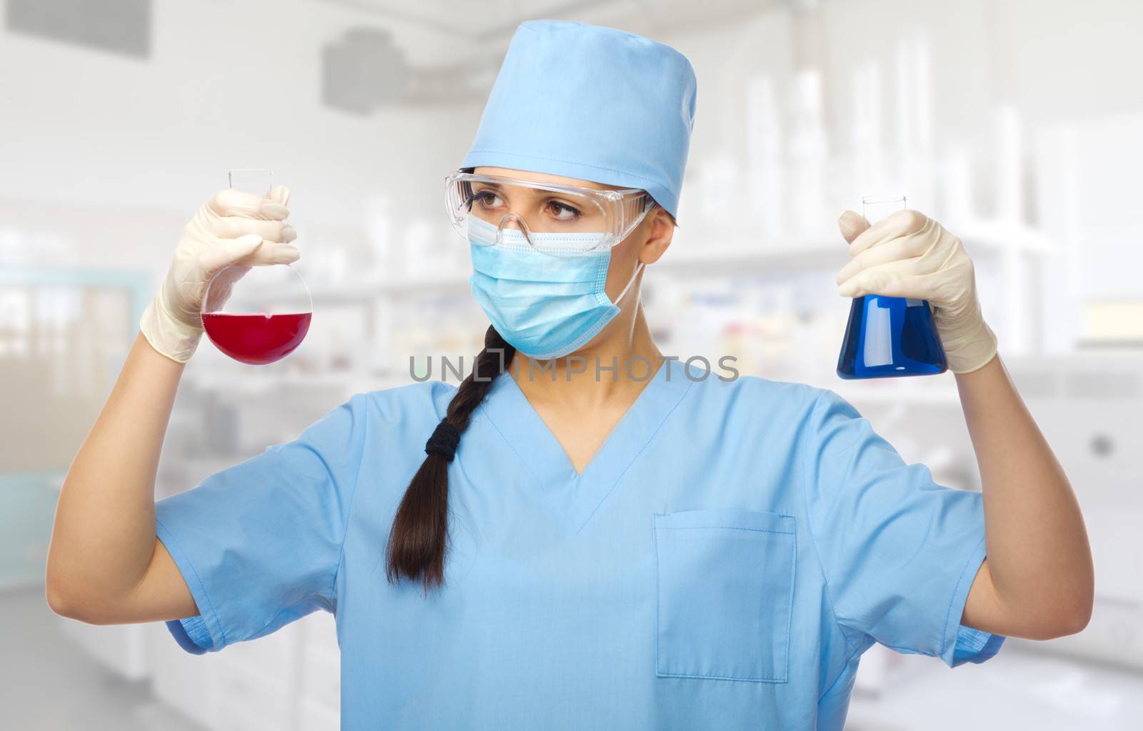 Young chemist with vials at lab