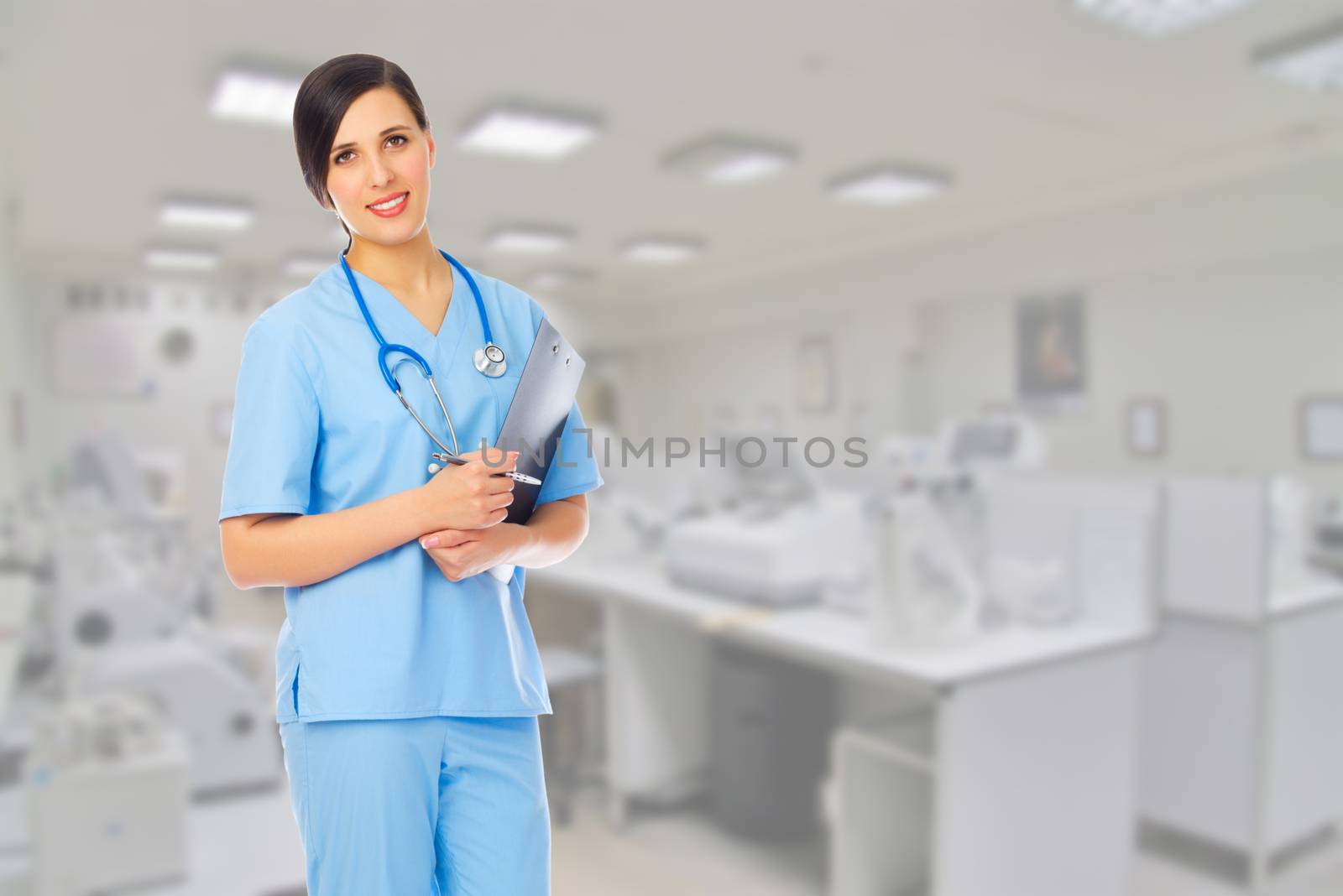 Young doctor with clipboard at medical office