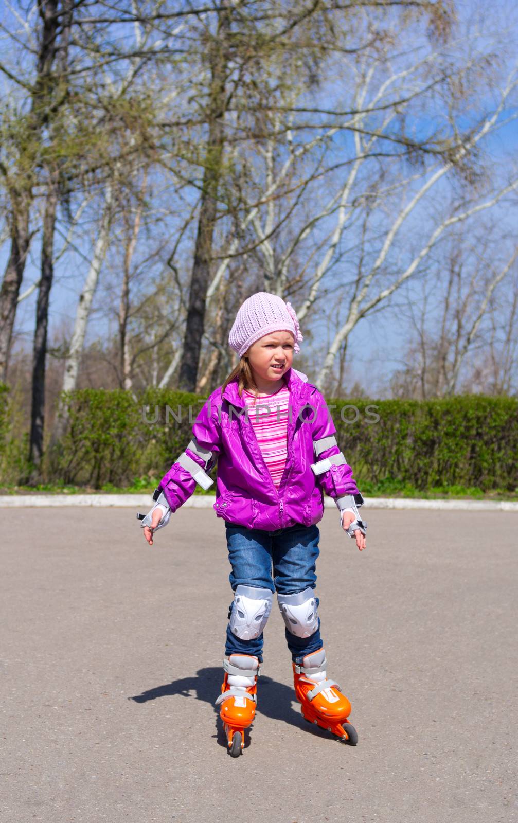 Little girl rides roller skates by rbv