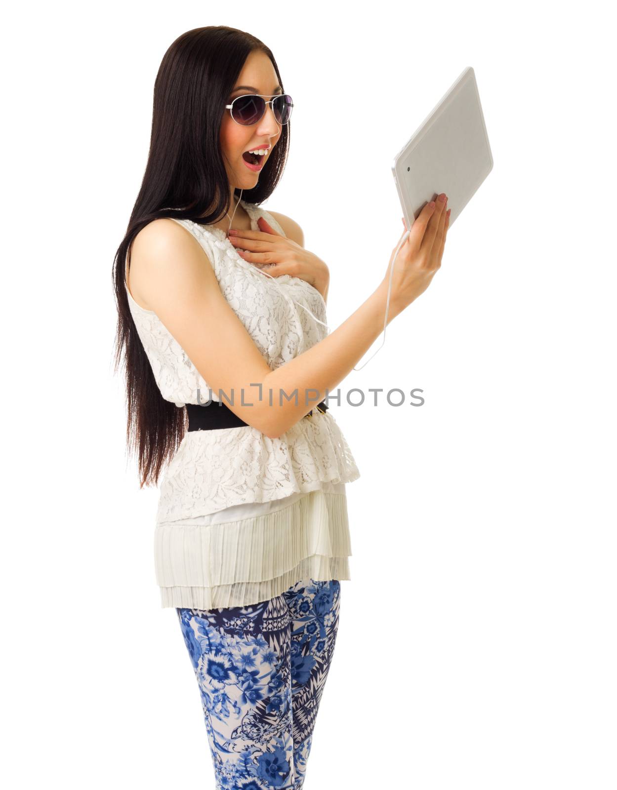 Young girl talks by tablet PC isolated