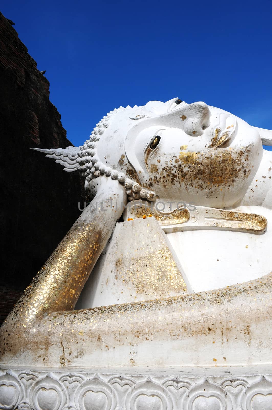 Giant Reclining Buddha at an Ancient buddhist wat in Ayutthaya, Thailand