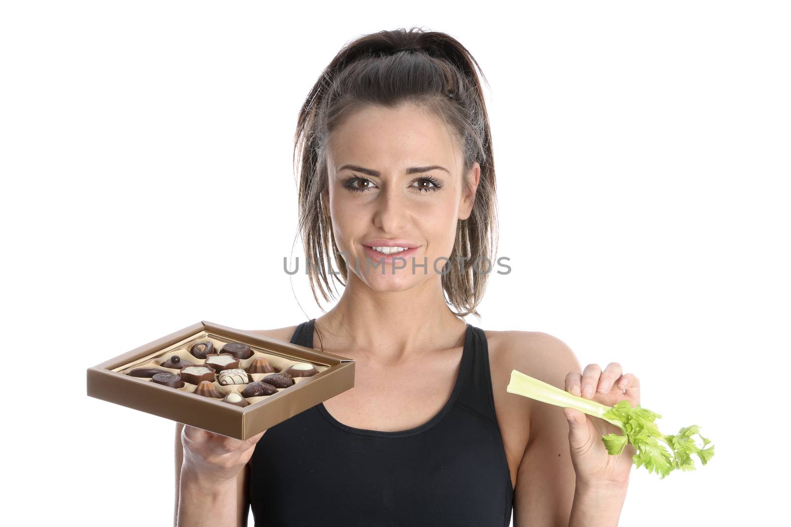 Model Released. Woman Holding Celery and Chocolates by Whiteboxmedia