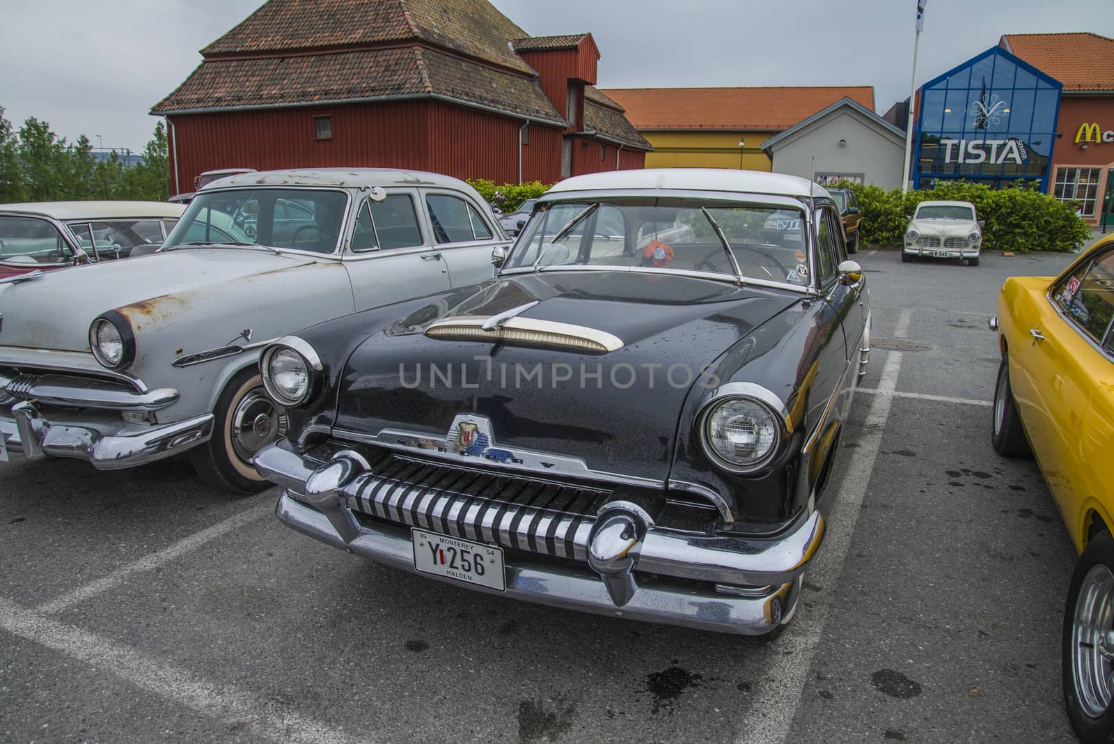 The image is shot at a fish-market in Halden, Norway where there every Wednesday during the summer months are held classic American car show.