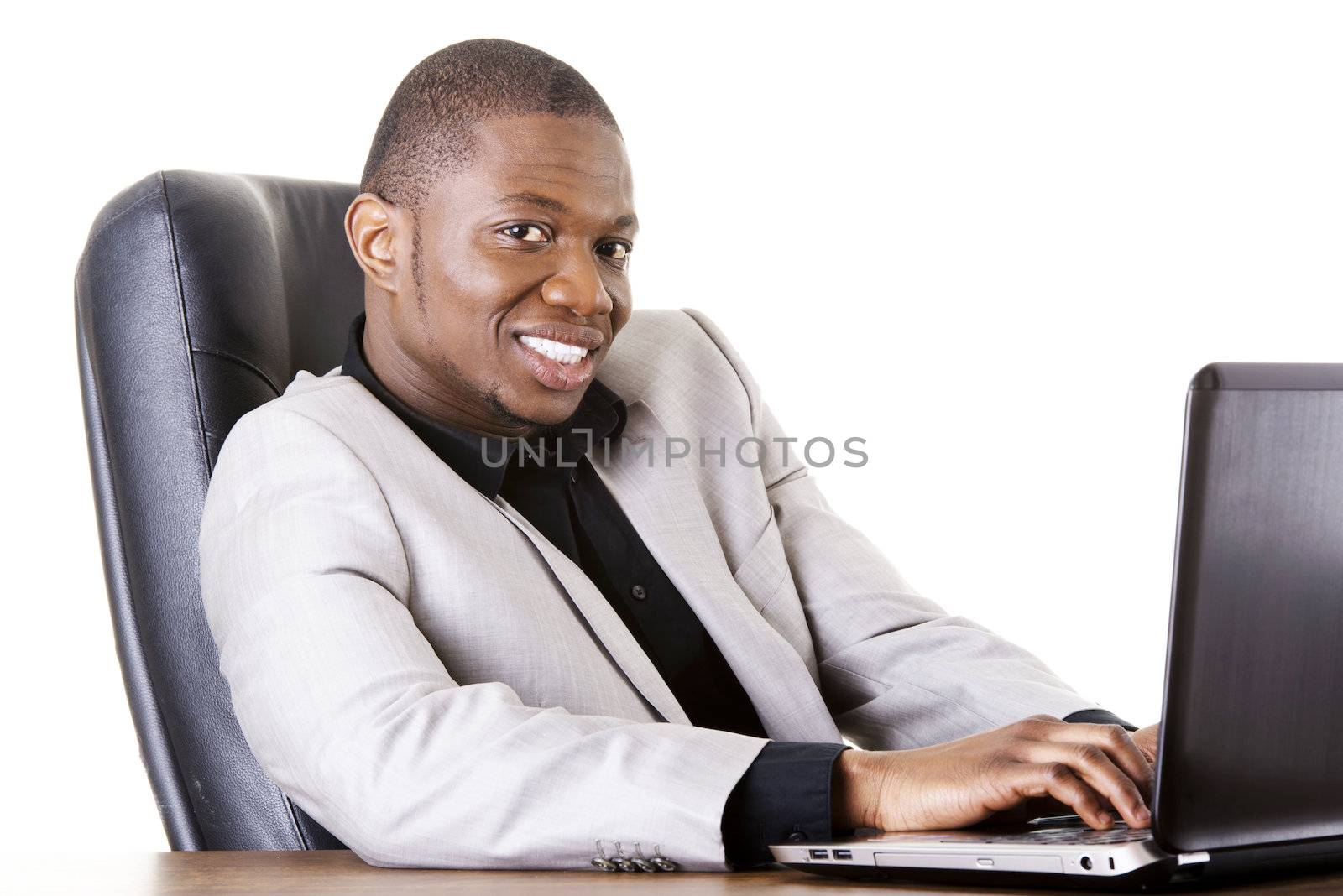 Successful businessman working on laptop, isolated on white