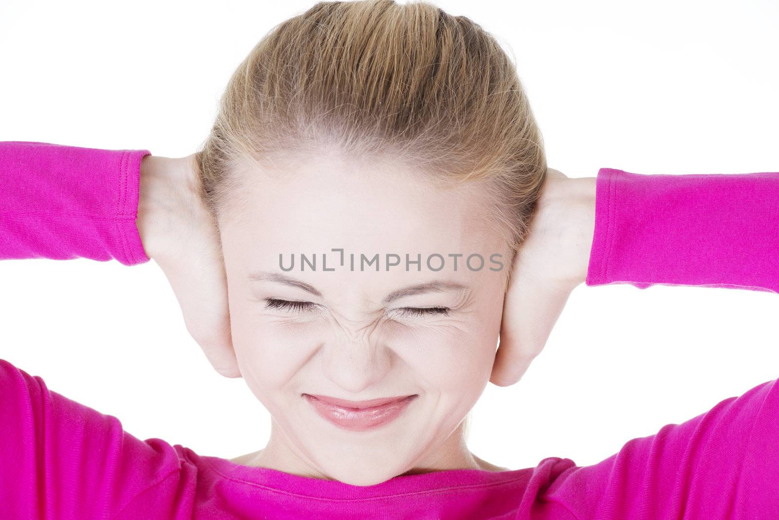 Closeup of frustrated young woman holding her ears. by BDS