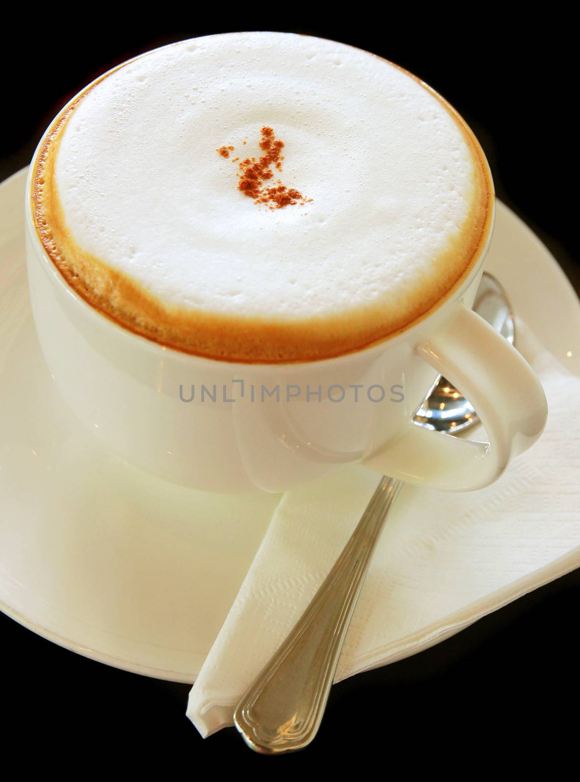 Coffee latte or cappuccino in a cup on black background by nuchylee