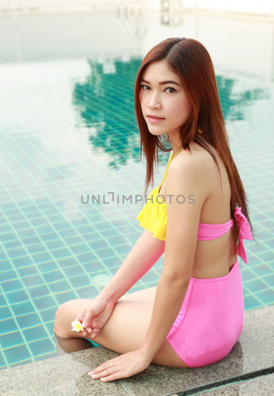 woman sitting at the swimming pool by geargodz