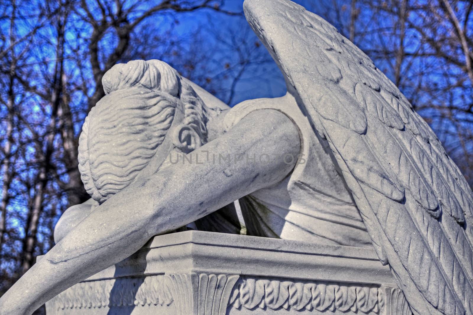 View of crying angel monument in a cemetery
