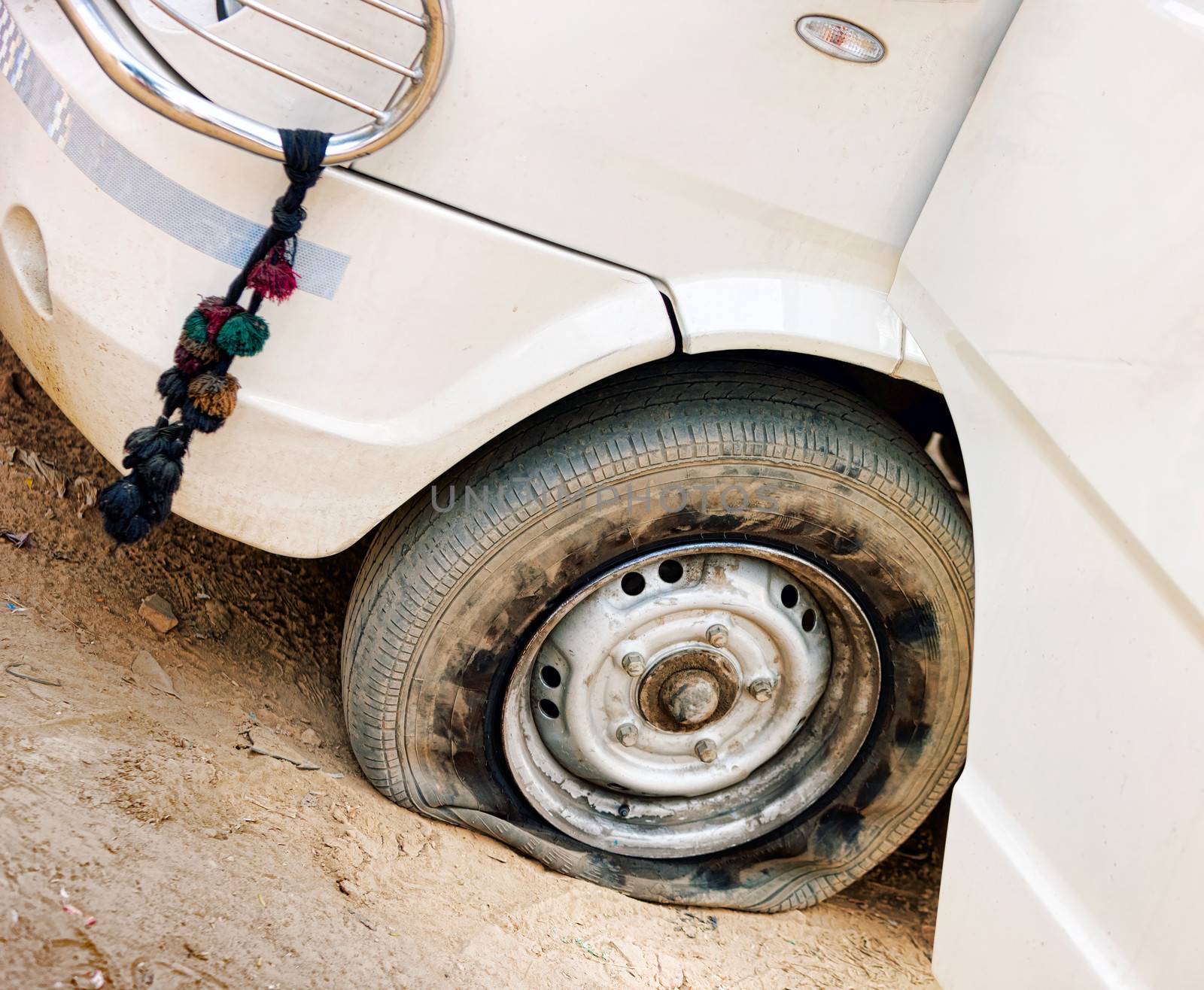 Flat tire of white car by vladimir_sklyarov