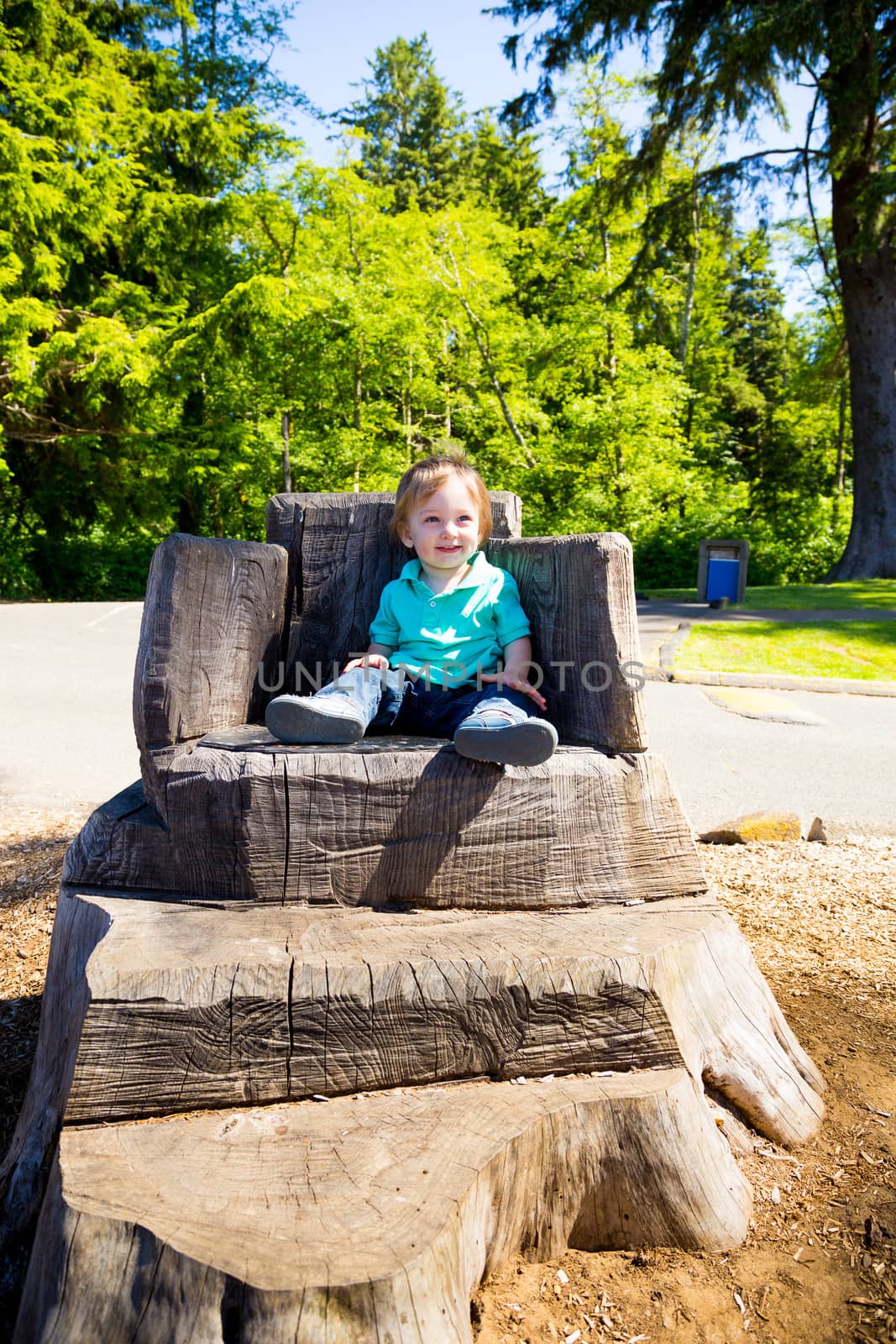 Boy Sitting on Stump Chair by joshuaraineyphotography