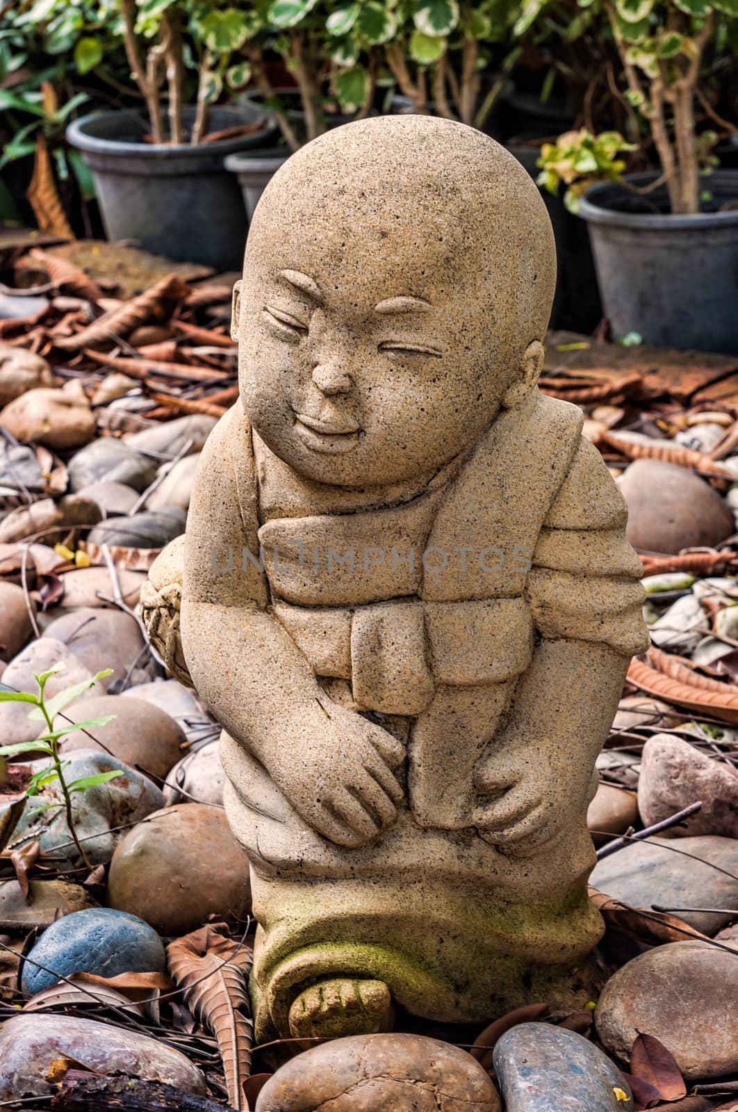 Funny traditional Thai garden monk sculpture