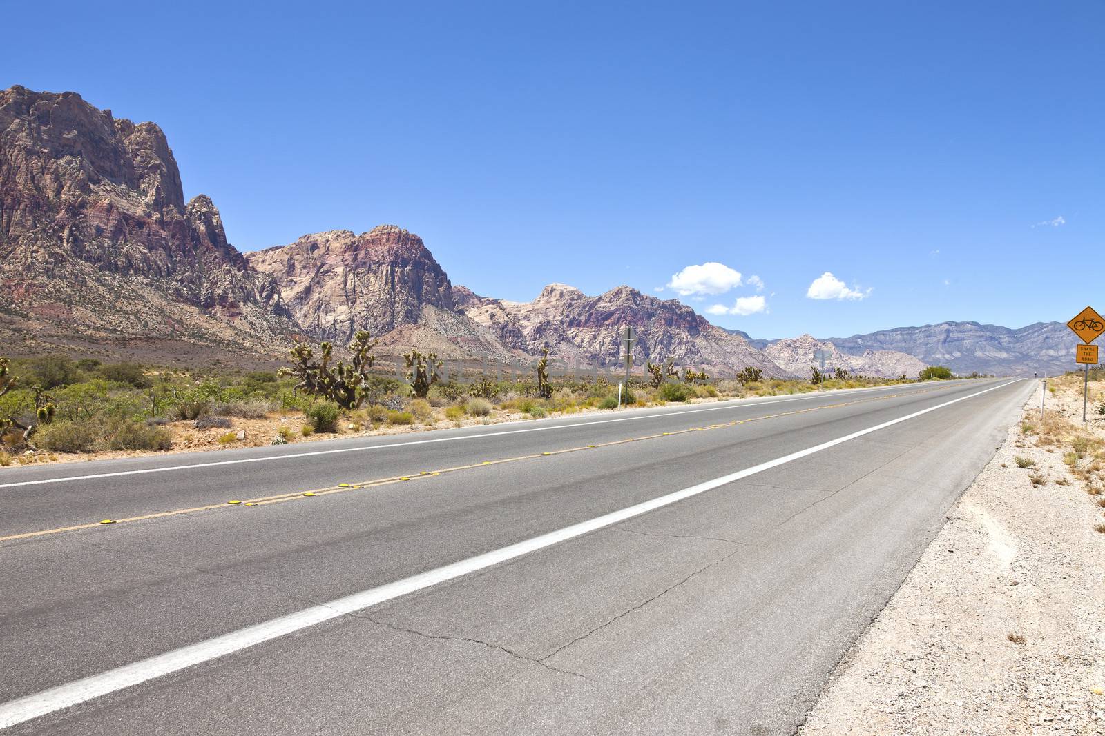 Red Rock Canyon road leading to Las Vegas NV. by Rigucci