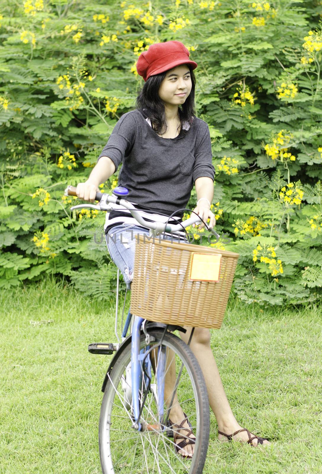 Young woman with retro bicycle in a park - outdoor portrait 