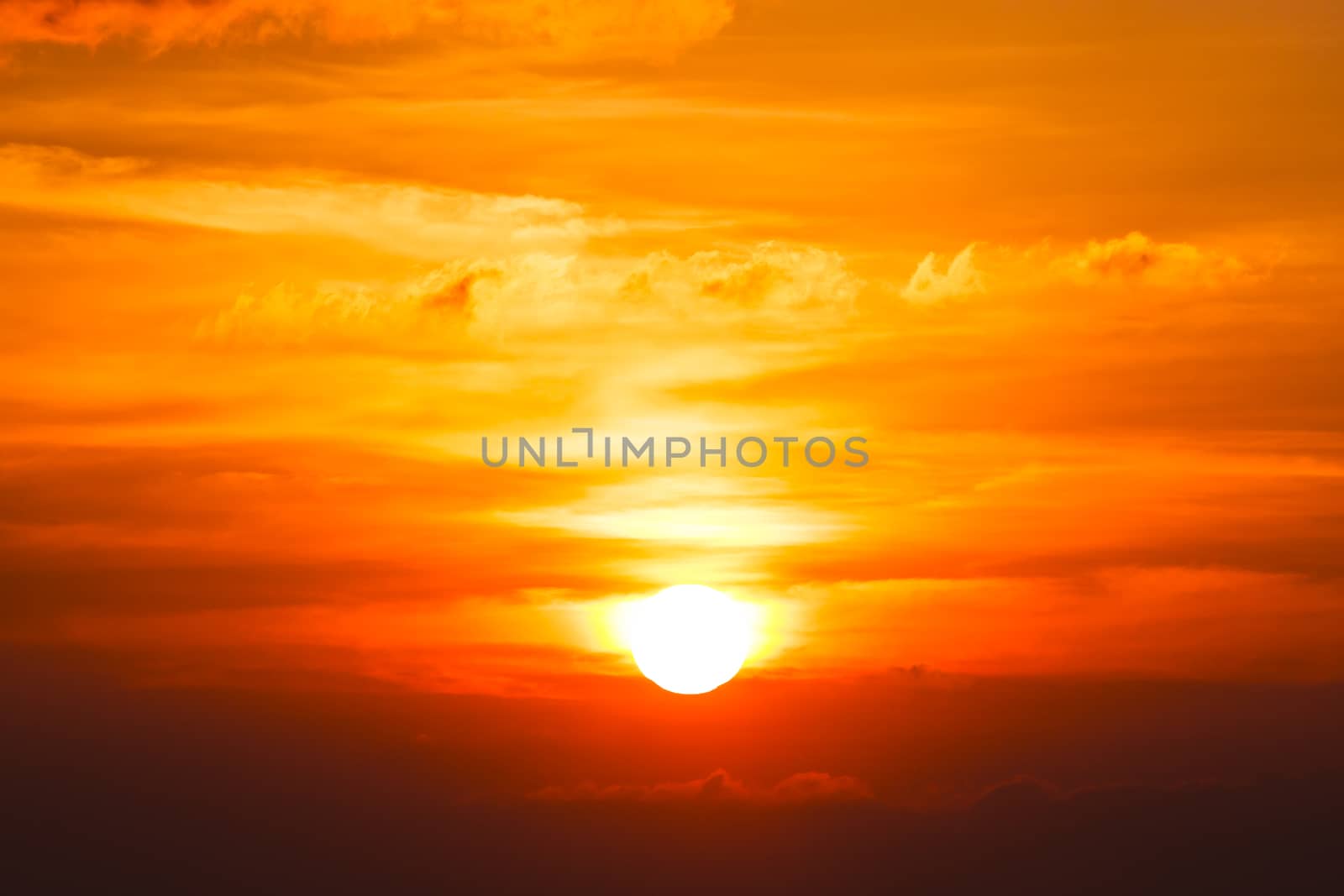 Brilliant orange sunrise over clouds in Iowa with bright yellow sun