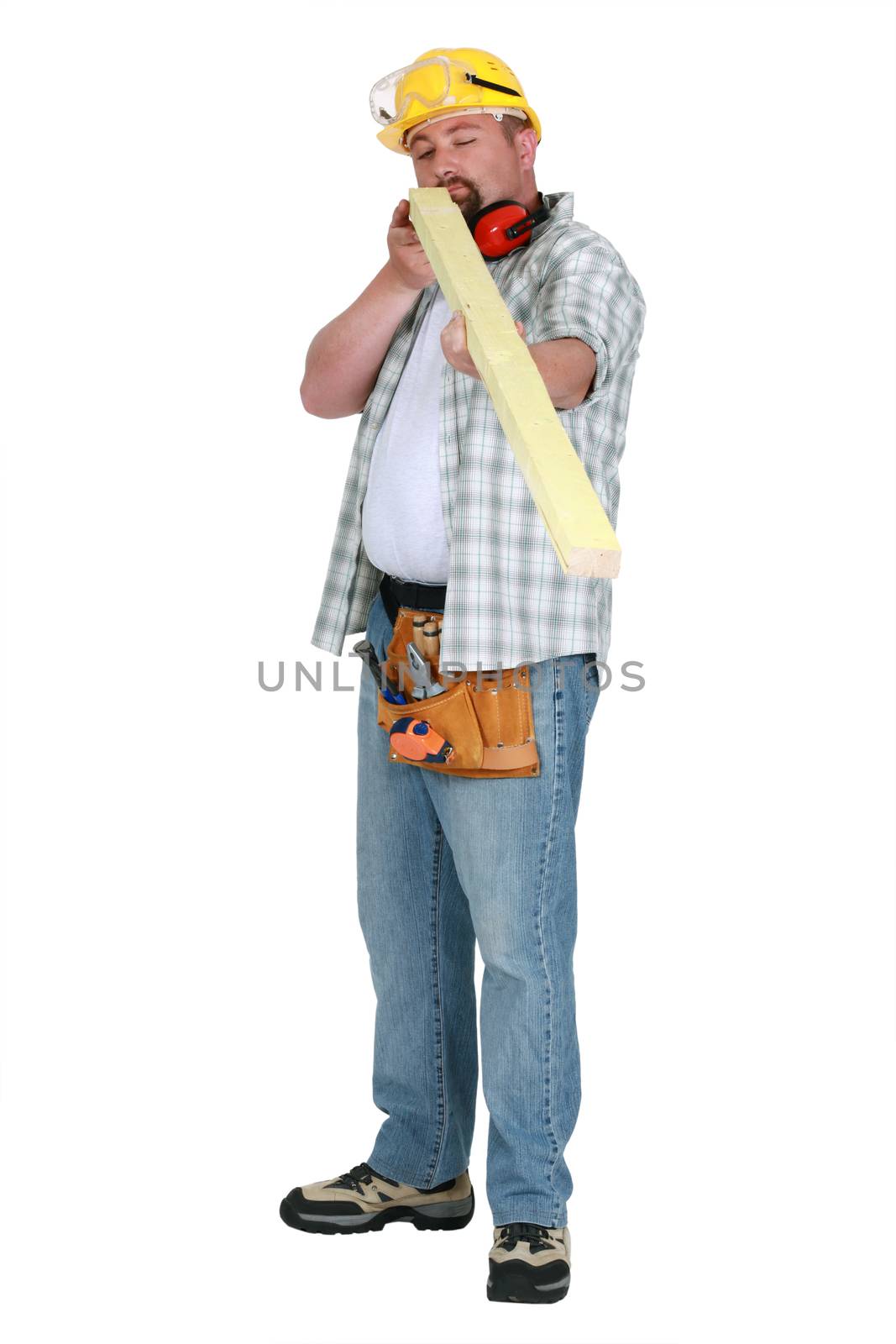 Man checking plank of wood for imperfections