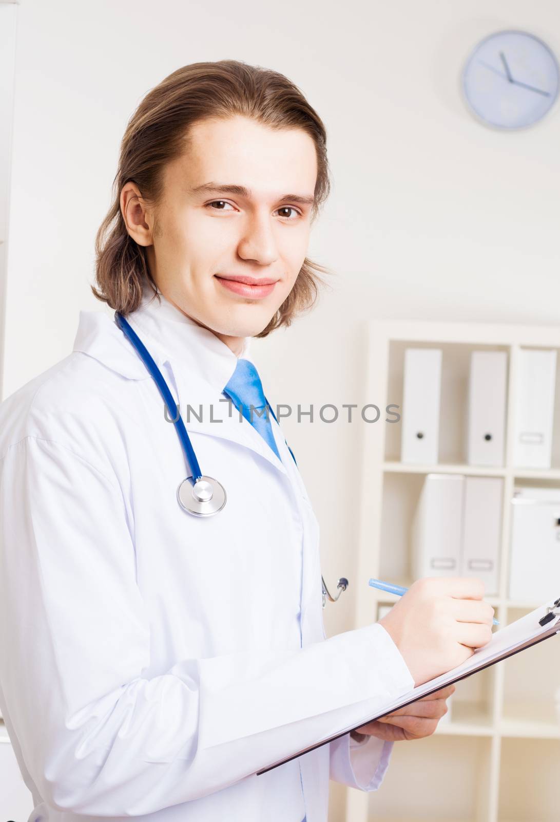 portrait of a doctor with a clipboard takes notes